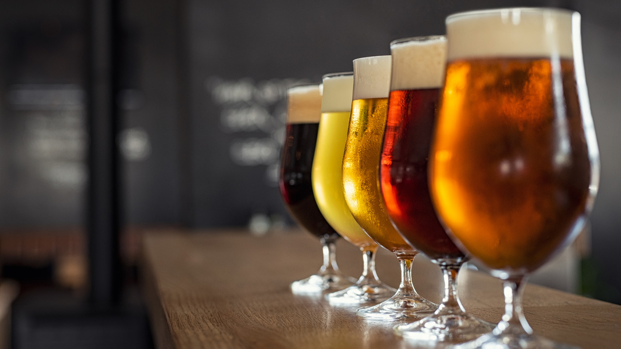 A photograph of five glasses of beer