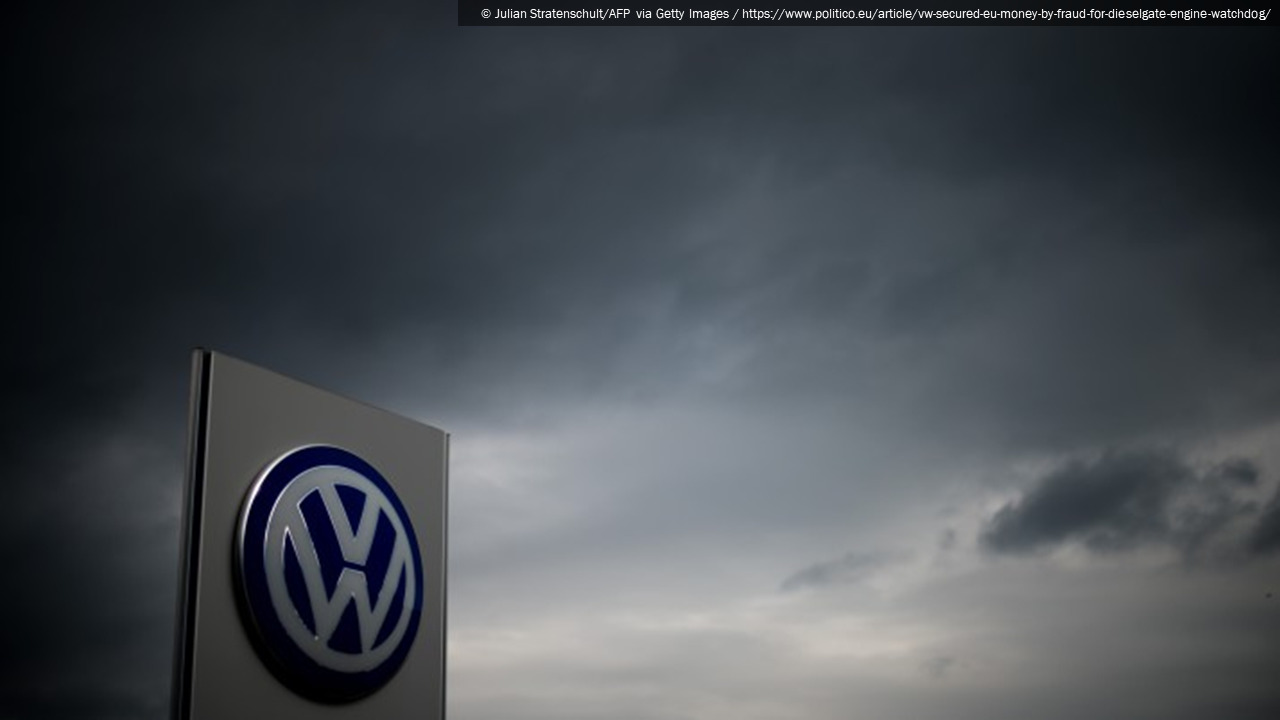 Photograph of a Volkswagen dealership sign beneath a cloudy gray sky