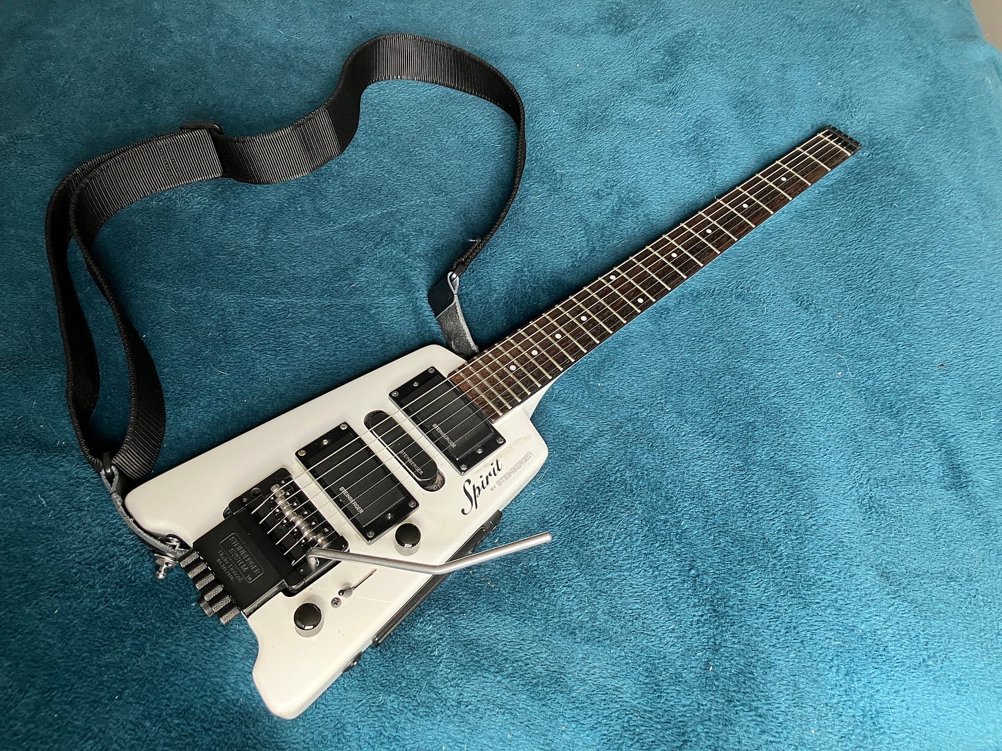 A white Steinberger Spirit headless guitar