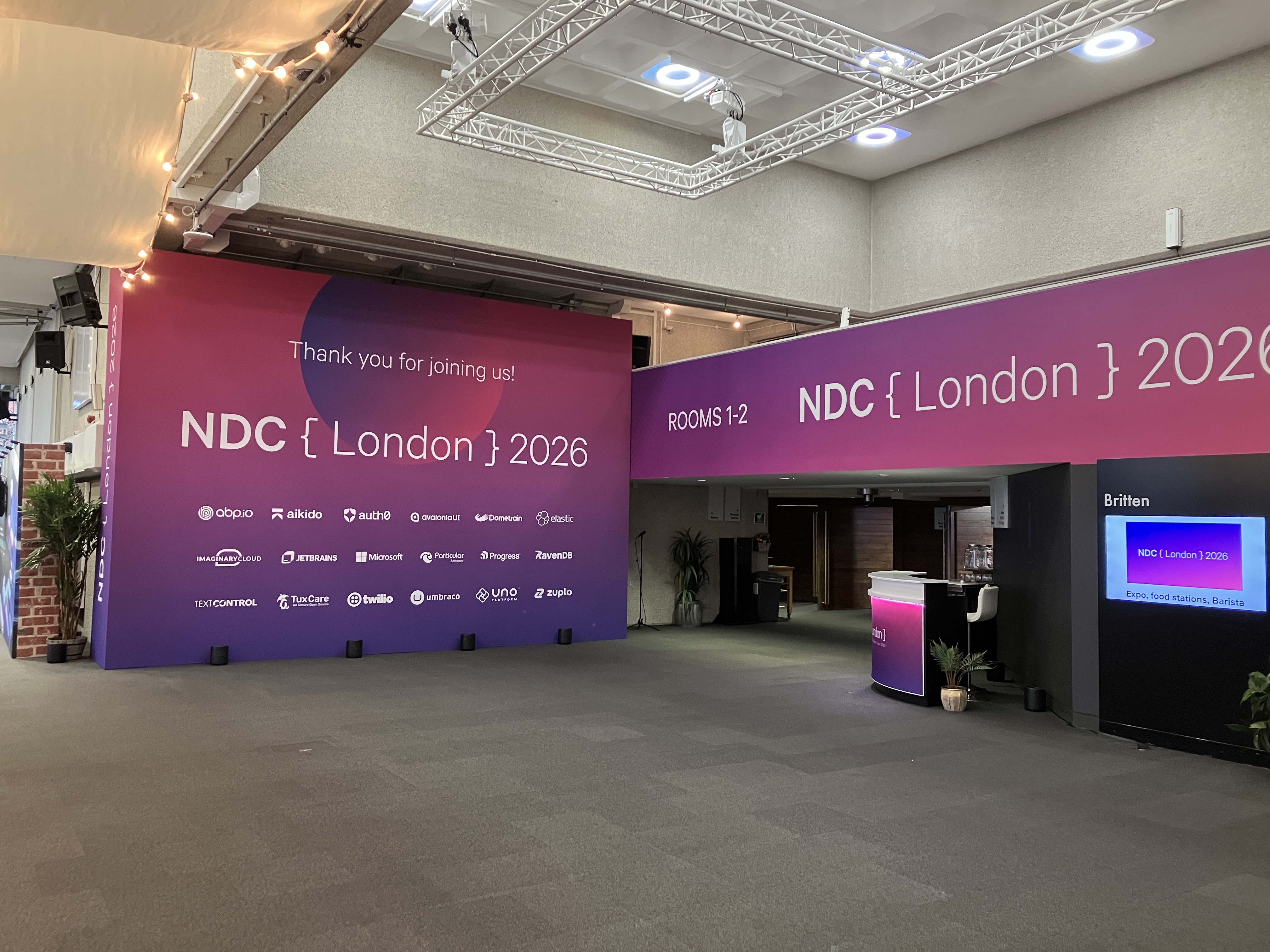 An empty conference venue, decorated and set up for NDC London 2026 but with no people yet.